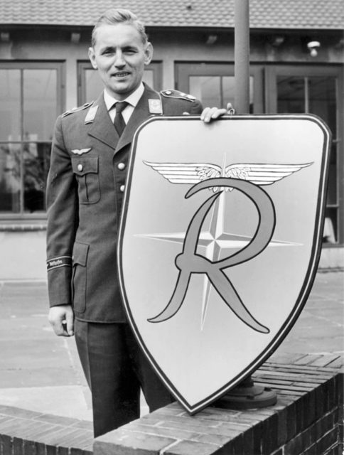 Erich Hartmann holds the insignia he designed