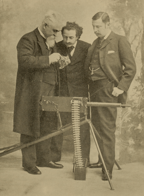 Hiram Maxim, Louis Cassier and J. Bucknall Smith standing with a Maxim gun