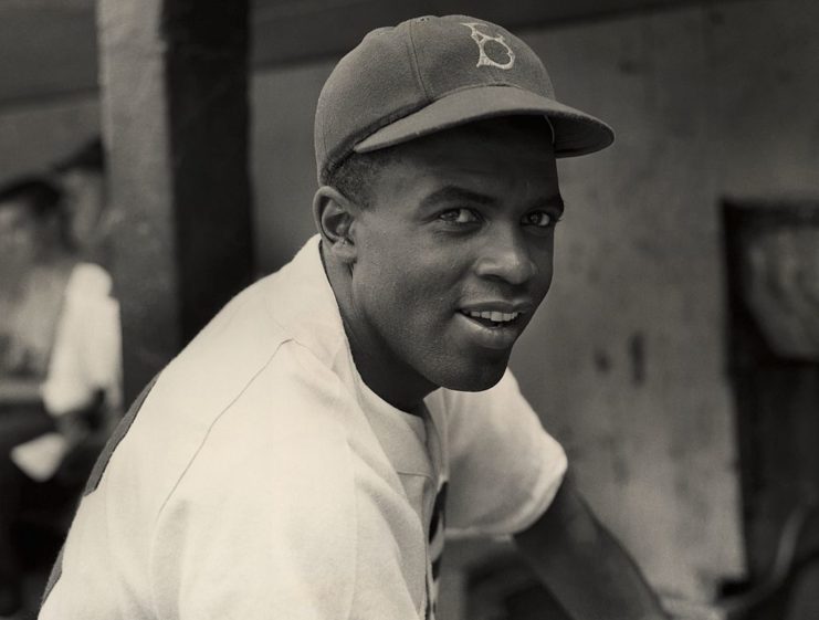 Jackie Robinson posing in his Brooklyn Dodgers uniform