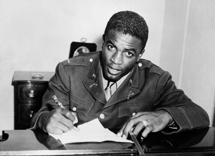 Jackie Robinson signs contract wearing Army uniform