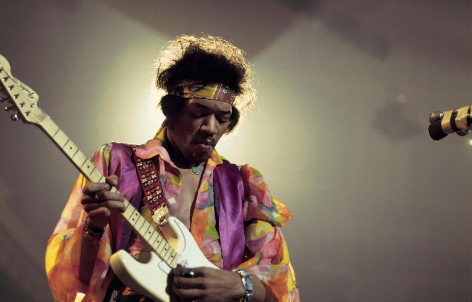 Jimi Hendrix performing on stage