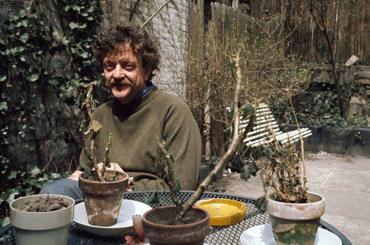 Kurt Vonnegut sitting at a patio set