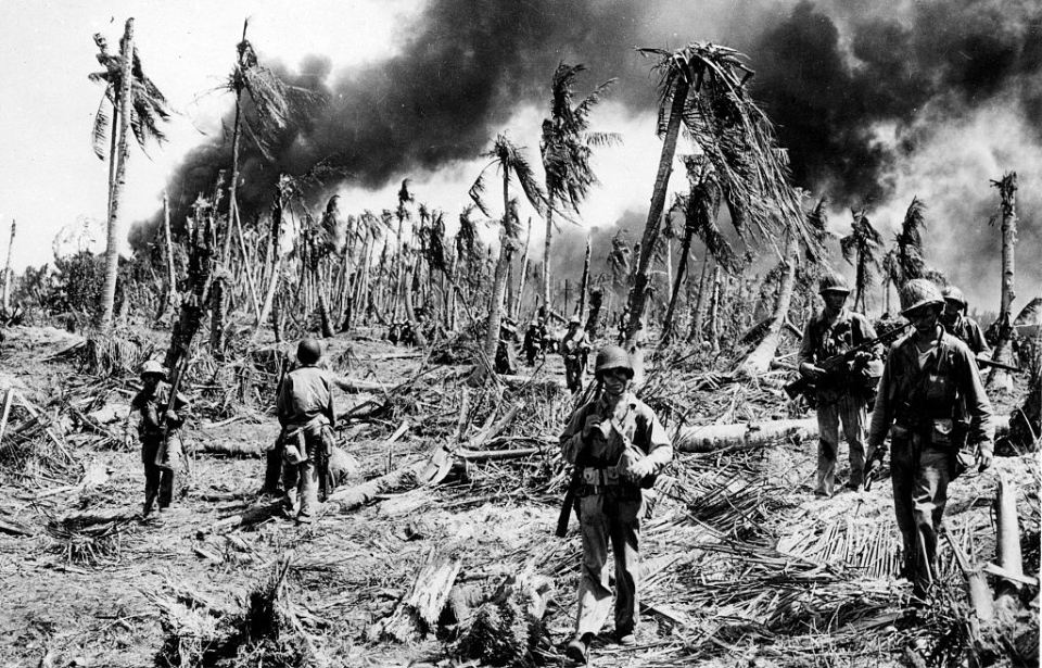 American troops standing among debris and damage