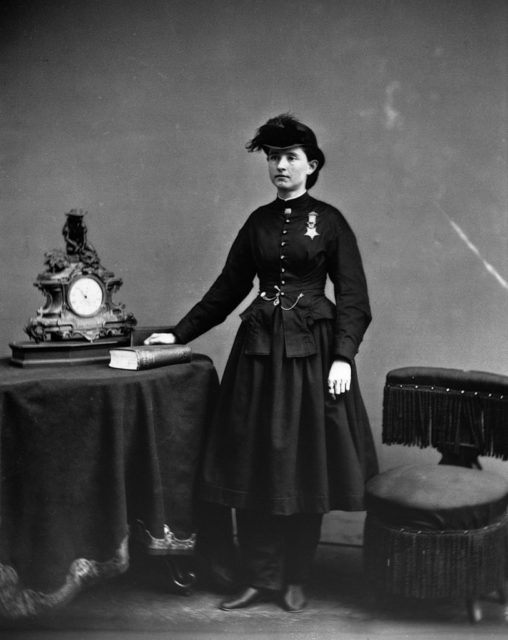 Mary Edwards Walker standing next to a table