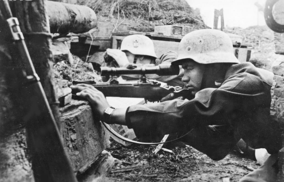 German sniper team with Mauser Karabiner 98k rifles fitted with a Dialytan RH36 4×32 telescopic sight in position amongst rubble