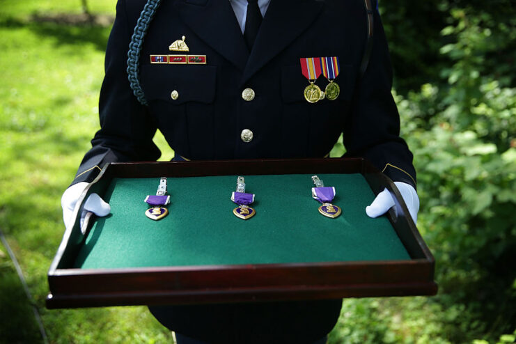 US Army Honor Guard holding three Purple Hearts