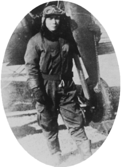 Shigenori Nishikaichi standing next to the wheel of an aircraft