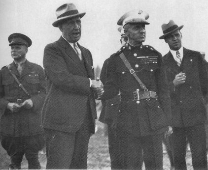 Smedley Butler standing with military officials