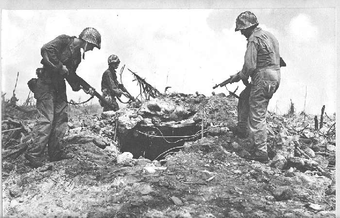 US Infantry soldiers inspect a Japanese bunker