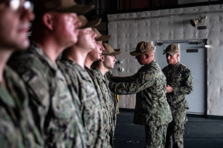 Senior US Navy official conducting a uniform inspection