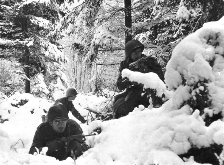 Infantrymen with the 7th Infantry Division crouched in the snow