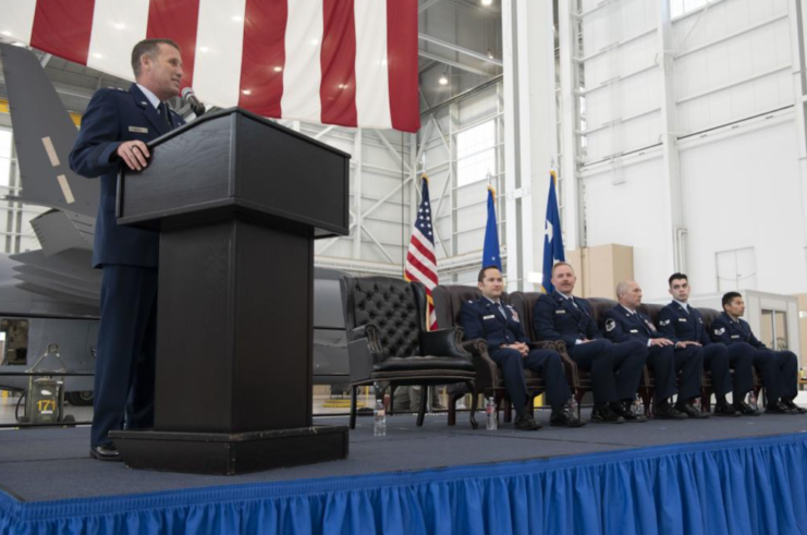 Maj. Gen. Matthew J. Burger speaking next to Lt. Col. Dominic Calderon, 1st Lt. Kyle Anderson, Master Sgt. Silva Foster, Senior Airman Michael Gellar and Staff Sgt. Dennis Gonzales-Furman