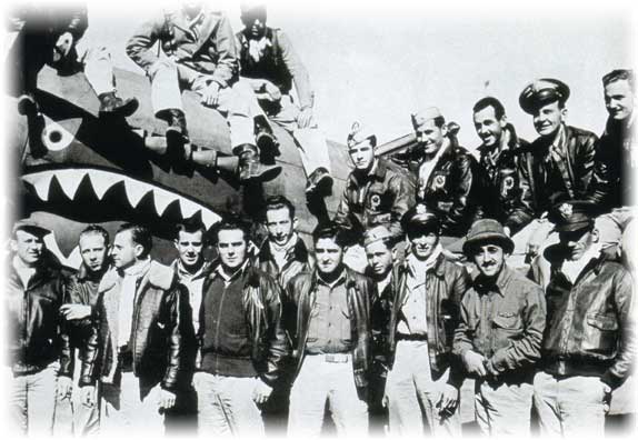 Flying Tigers personnel standing in front of a P-40 Warhawk