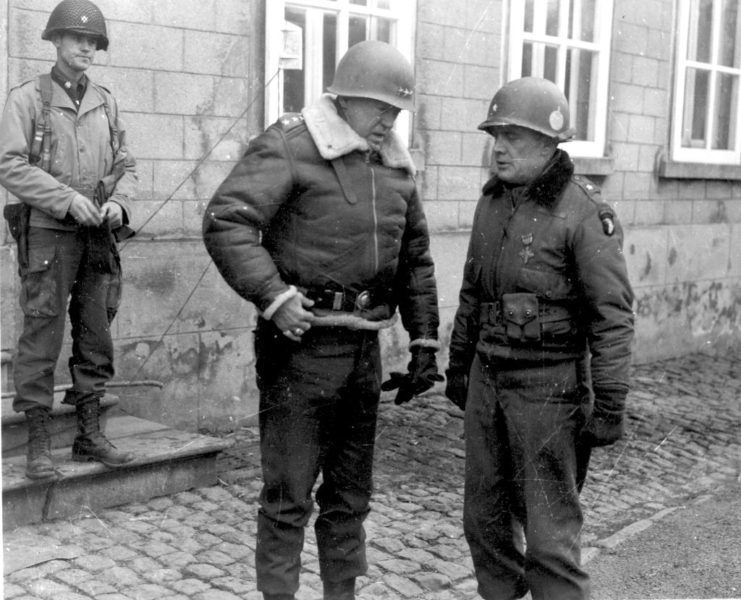 General George S. Patton and Brigadier General Anthony McAuliffe discuss plans in Bastogne, Belgium