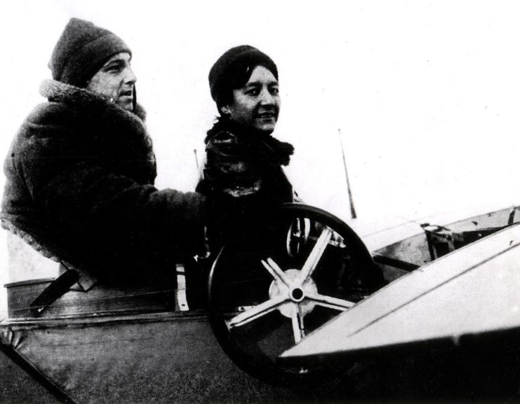 Marie Marvingt and Hubert Lathem sit in an airplane 