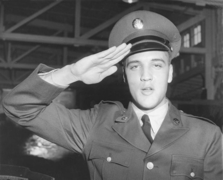 Elvis Presley saluting in his US Army uniform