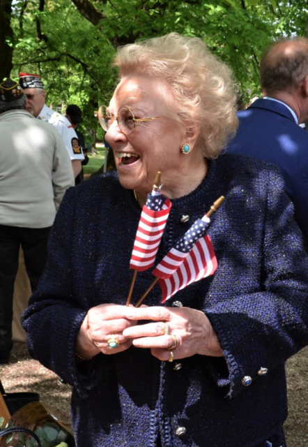 Meri Mion holding miniature American flags