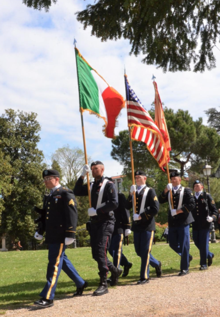 Soldiers walking with American and Italian flags