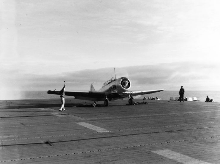 A SNJ-3 training plane prepares to take off from USS Long Island's deck during training in 1943.