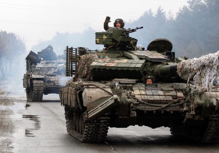 Ukrainian forces riding in tanks