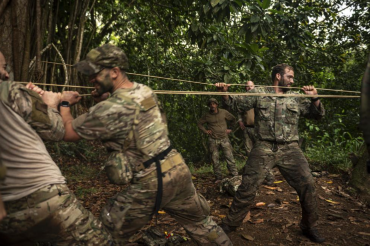 Special Forces Airmen pulling a rope