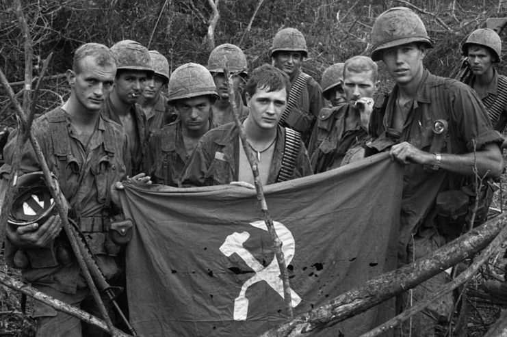 US soldiers holding a People's Labor Party flag