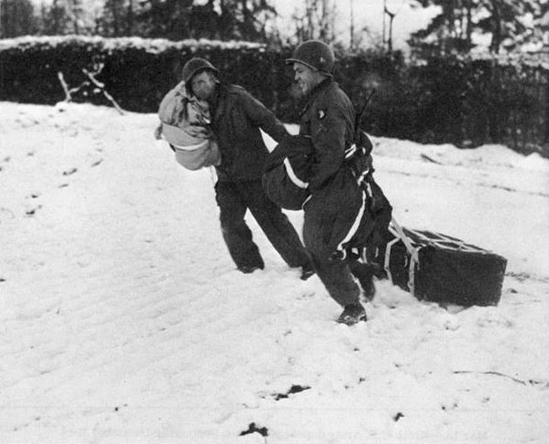 Two members of the 101st Airborne Division carrying supplies