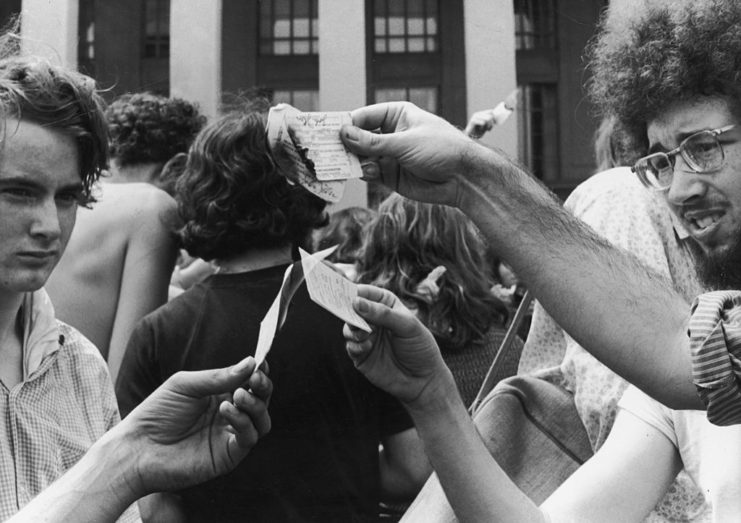 Protestors burning their Vietnam War draft cards