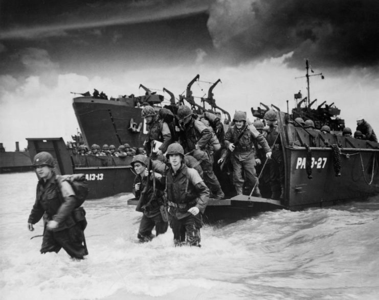 Allied soldiers disembarking from a landing barge
