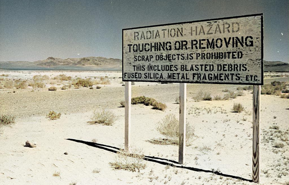 Sign warning of radiation in a desert area