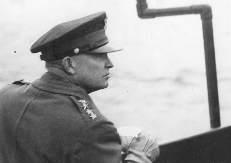 Dwight D. Eisenhower looking out the side of a ship