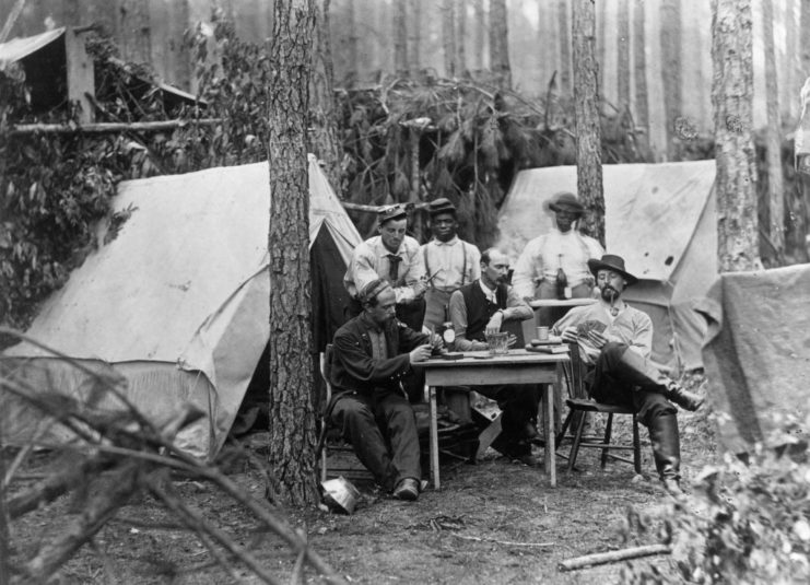 Confederate soldiers playing cards at camp