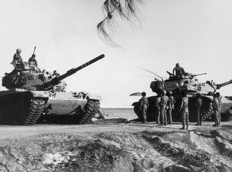 Two tanks and their crew in the desert