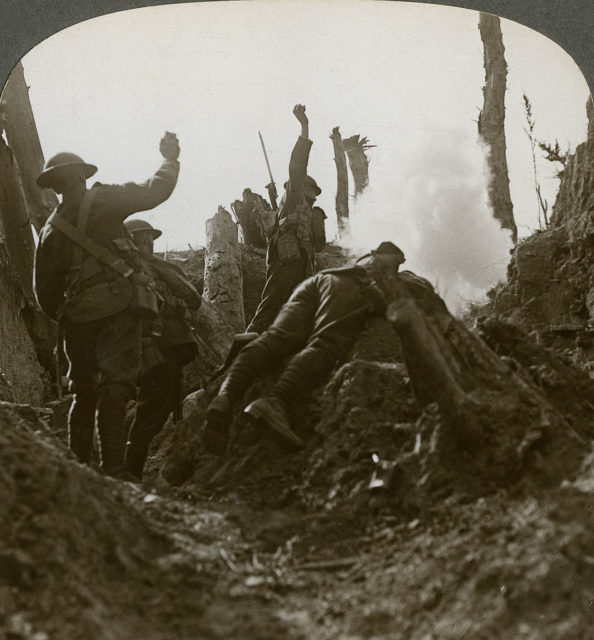 Soldiers throwing grenades from a trench