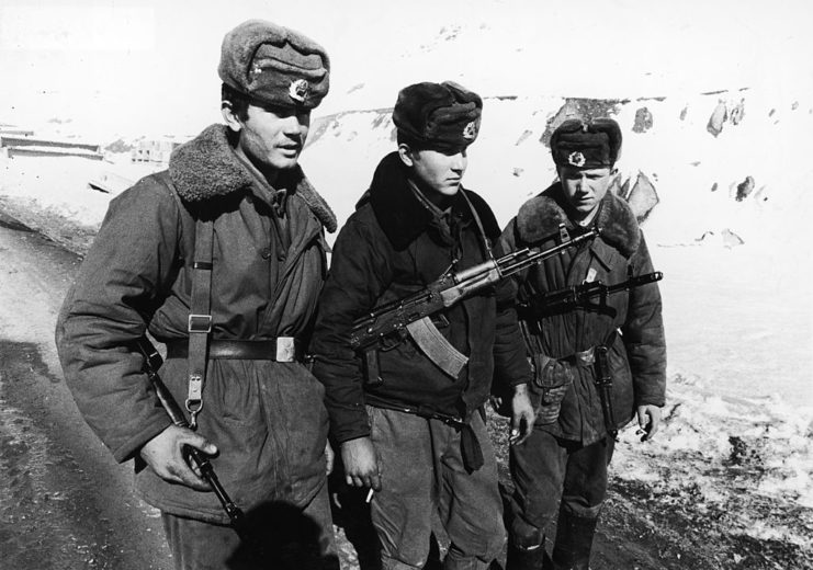 Three armed Soviet soldiers standing together