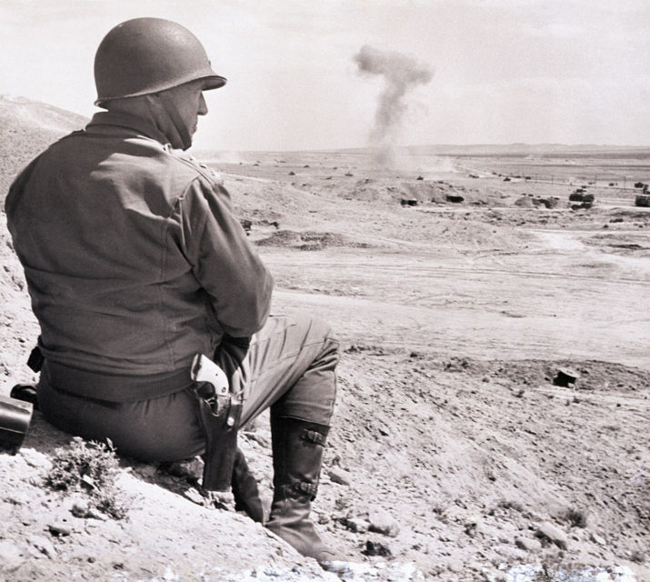 Gen. George Patton sitting on a dirt mound