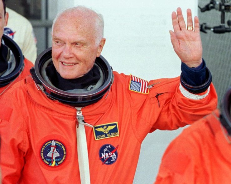 John Glenn waving while wearing his spacesuit