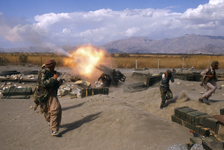 Mujahideen troops fire a 122 mm cannon