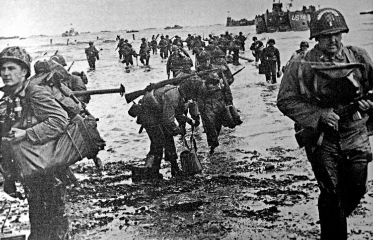 Allied soldiers wading through water