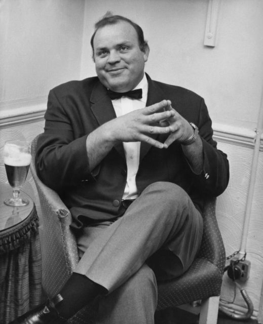 Dan Blocker sitting in a chair