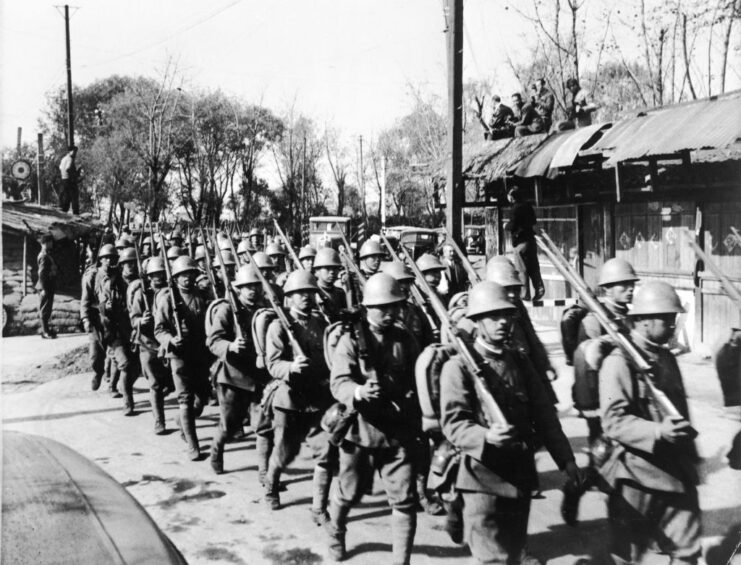 Japanese troops marching down a street