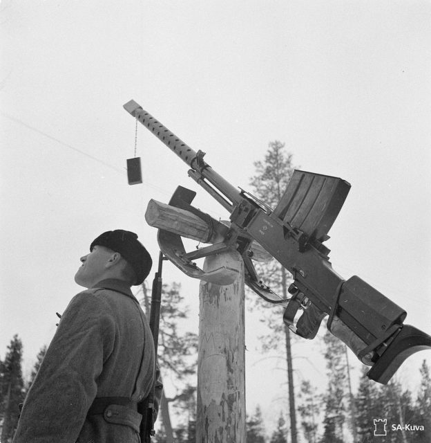 Finnish soldier standing beside a Lahti L-39