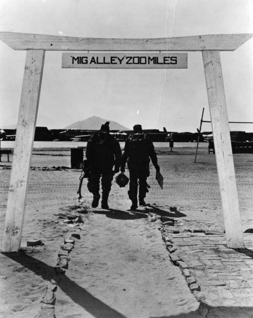 Two North American F-86 Sabre pilots walking through the torii gate at Kimpo (K-18) Air Base