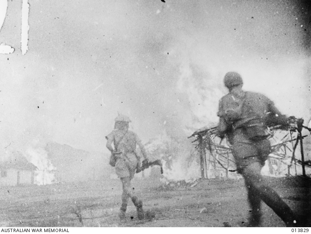 Two Australian troops running through smoke