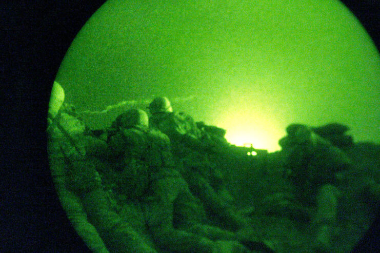 Five US Marines crouching in the sand