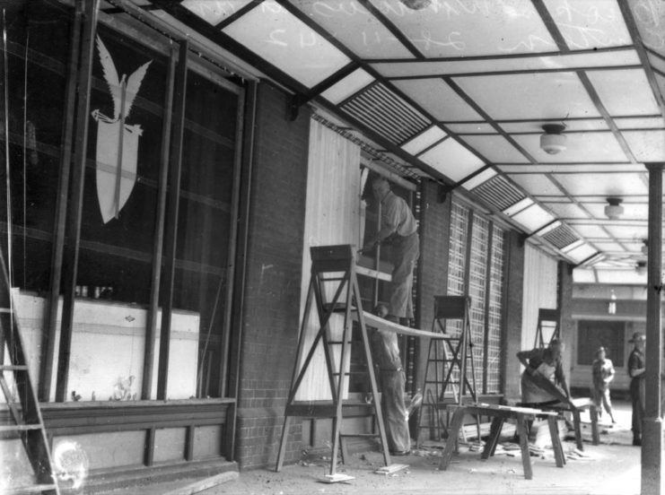 Workers repairing exterior windows