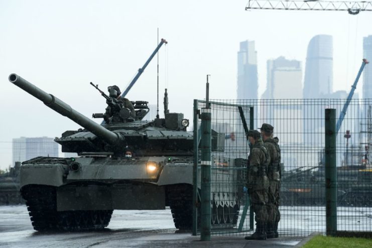 Russian soldier standing in the turret of a T-72B3 tank