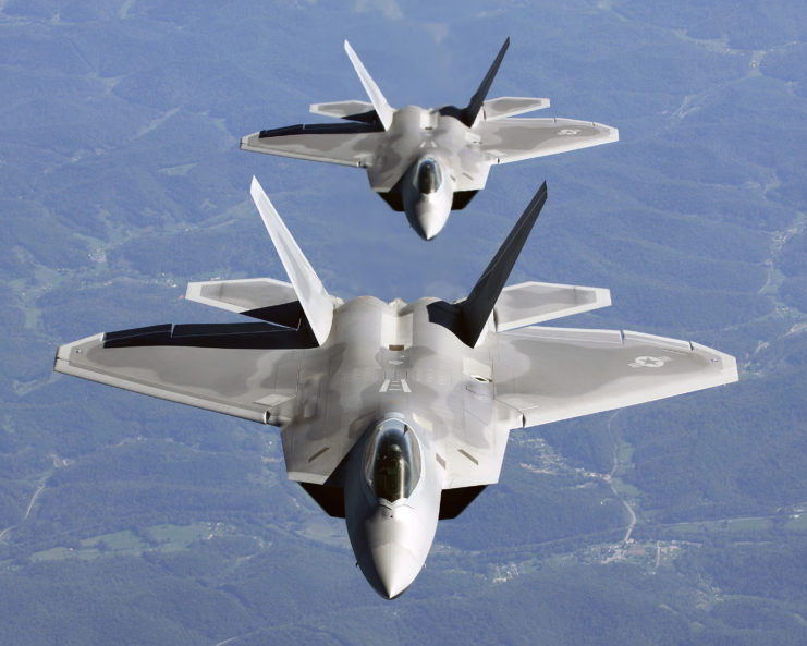 Two Lockheed Martin F-22 Raptors flying in formation