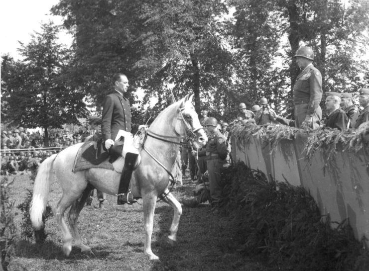 Alois Podhajsky sitting horseback before Gen. George Patton