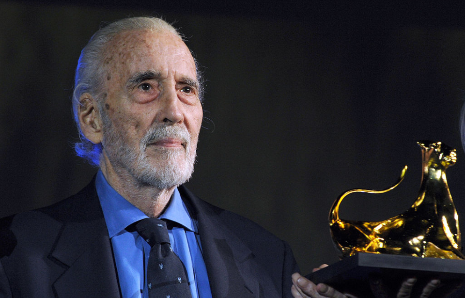 Christopher Lee wearing a suit and tie